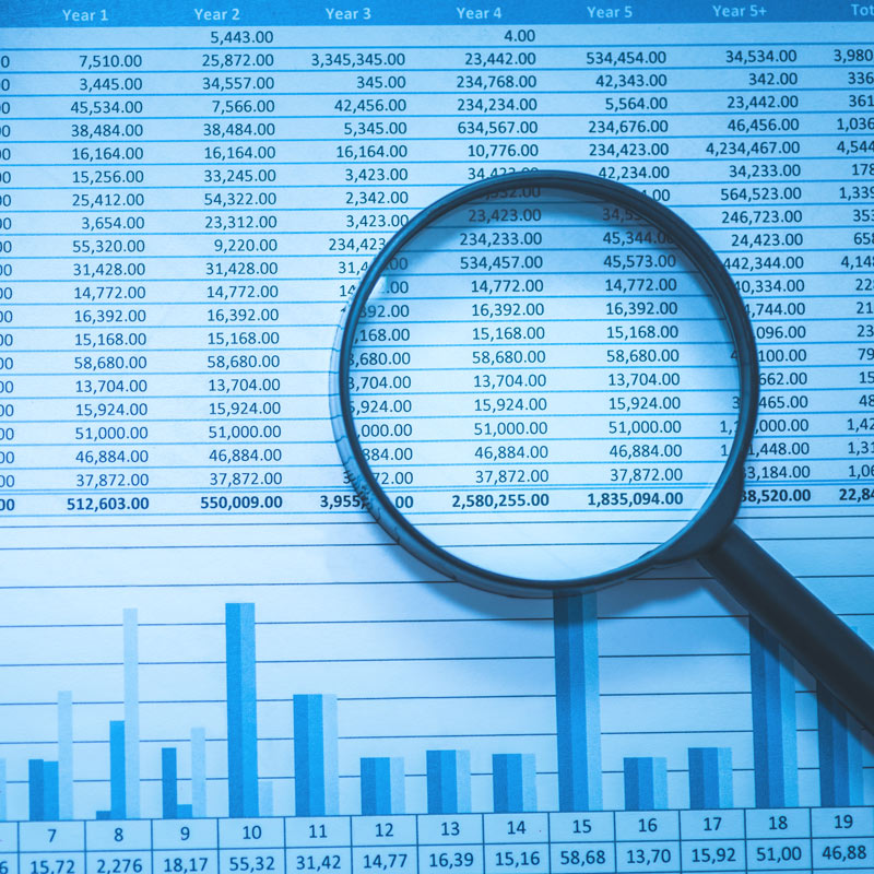 Magnifying glass sitting on top of a page of account numbers