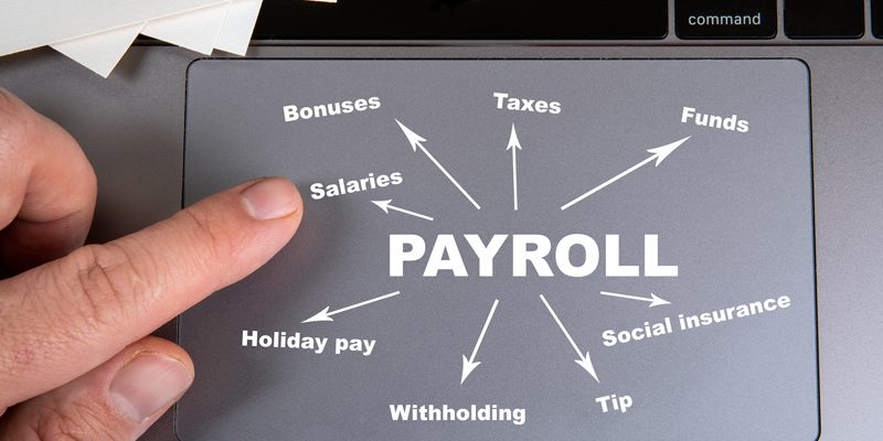 Tracking pad mouse with payroll list laid out on it