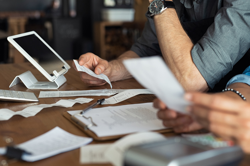 two people going over expenses with receipts