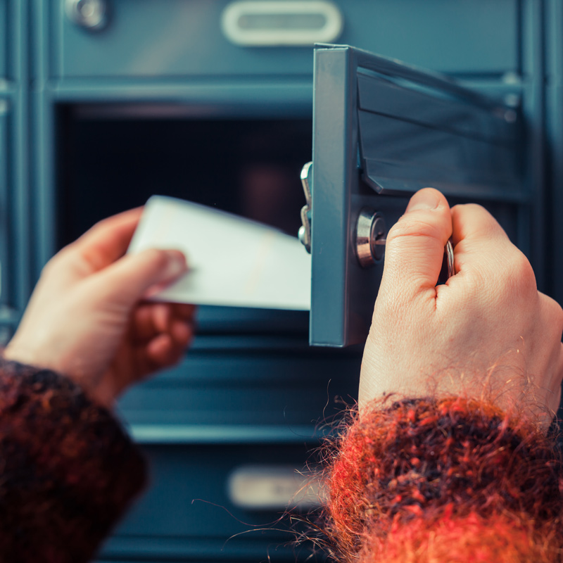 Person collecting mail from a post box