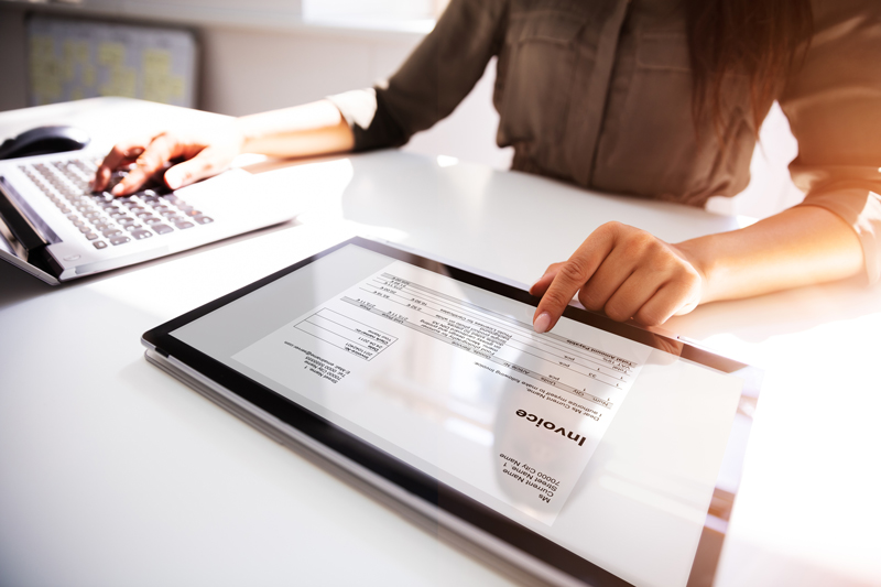 women checking digital invoice on tablet