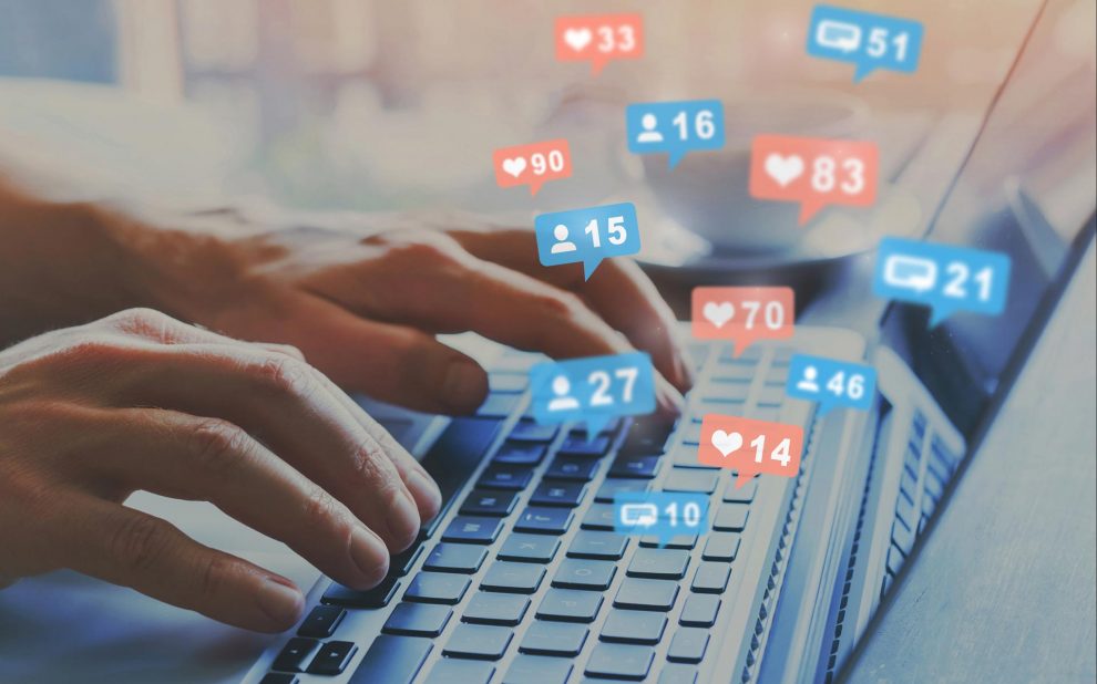 laptop with social media likes coming out of it